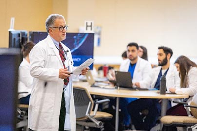 Attendees watch Grand Rounds presentation.