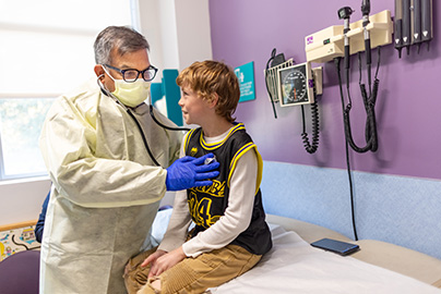 Dr. Jhawar with pediatric patient in medical office
