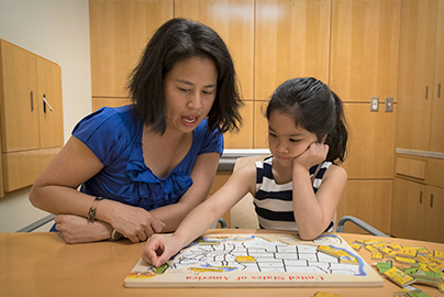 Dr. Angkustsiri with young female patient