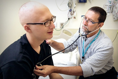 Pediatric hematology doctor examines oncology patient