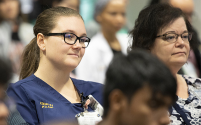 Human Genomic Seminar meeting in classroom with doctors seated in rows.