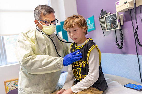 Dr. Jhawar with pediatric patient in medical office