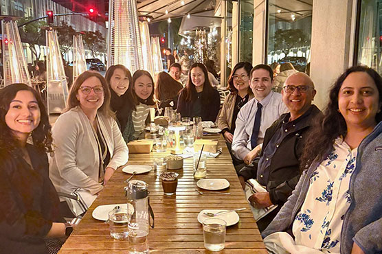 UCDH Allergy and Immunology Team photo of 9 members around dinner table