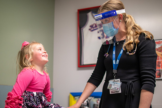 UC Davis gastroenterologist with young patient in an office check-up