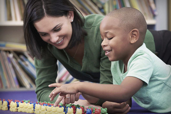 CAARE provider playing with young boy.