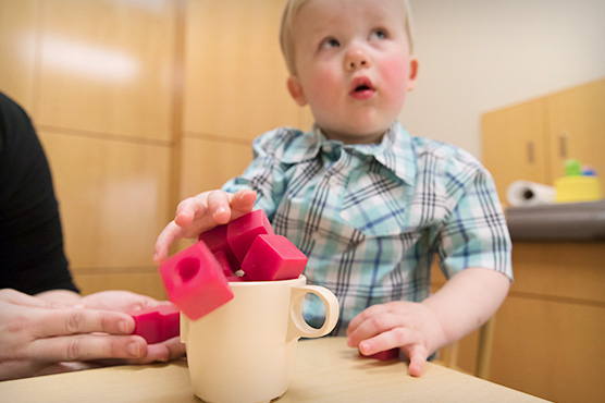 Young patient with blocks in cup at the MIND Institute
