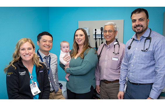 Cardiology staff with mom and infant who recieved special stint