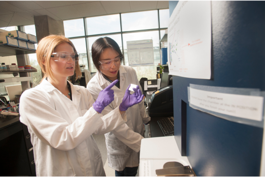 Two female researchers at UC Davis in a lab environment.