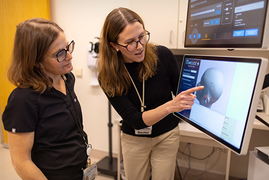 Two researchers looking at a monitor