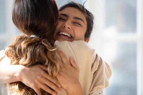 Two women hugging