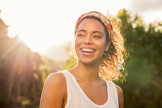 A young woman smiling outside