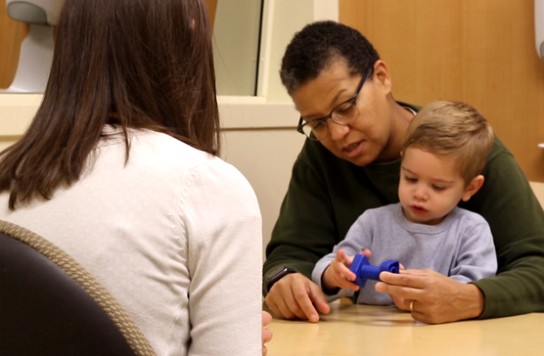 Two women playing with a baby