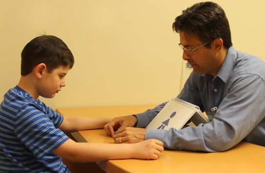 A man working with a child at a table