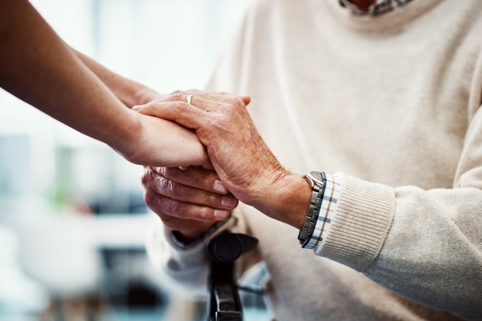 Two people holding eachothers hands