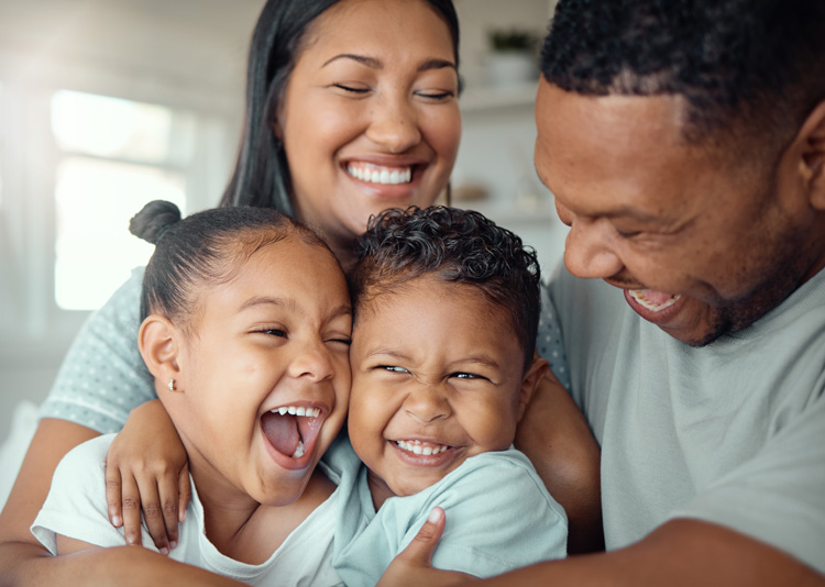 happy family sitting together and hugging, stock image