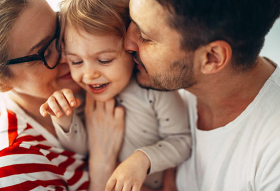 Mom and father face snuggling with their child