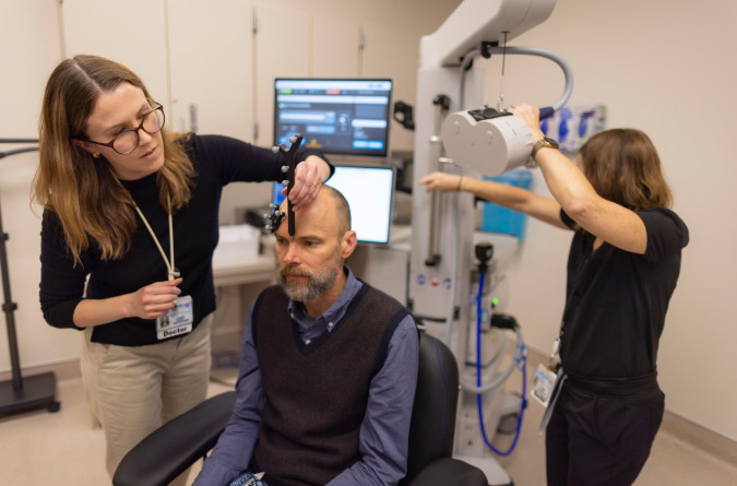 Practitioners use the TMS Therapy device at the APT clinic