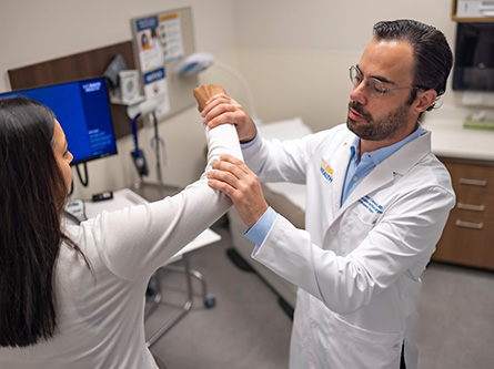 UC Davis doctor performing elbow exam on patient