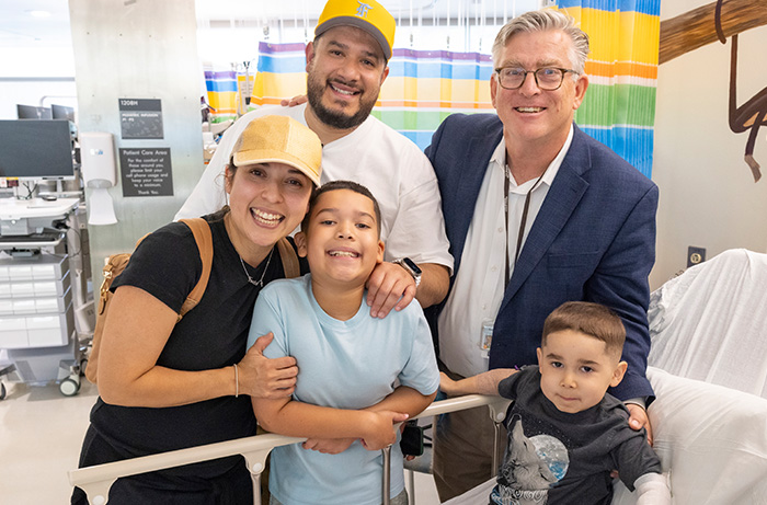 UC Davis patient with Duchenne muscular dystrophy receives gene infusion therapy, photo with family and Dr. Craig McDonald