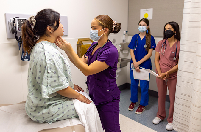 A healthcare worker interacting with a standardized patient actor.