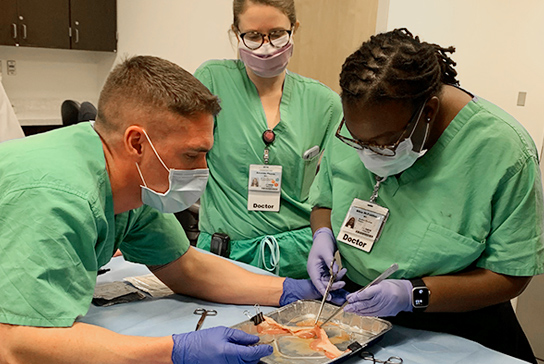 Three doctors woking an operation simulation.