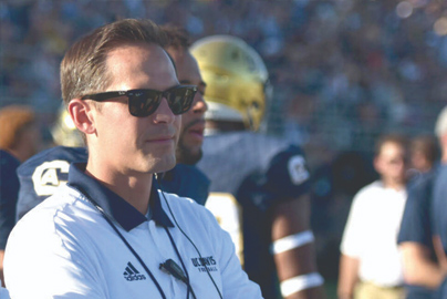 Jeremiah Ray, M.D. looking out on a football game.