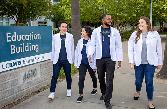 UC Davis School of Medicine students walking outside the Education Building