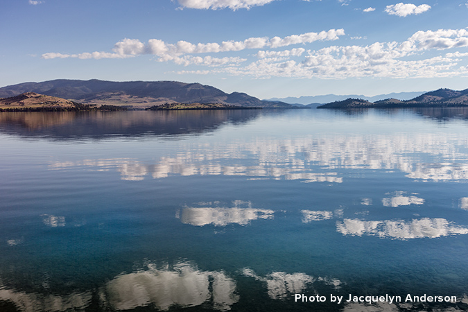 white clouds reflecting on water with blue sky&mdash;Photo by Jacquelyn Anderson