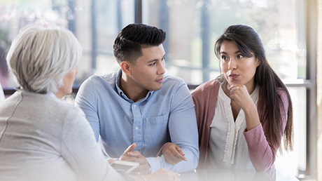 Couple discussing infertility concerns with a doctor