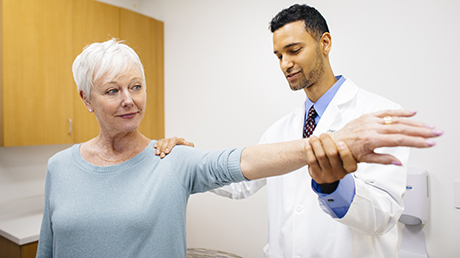 Orthopedic doctor Christopher Bayne and older patient