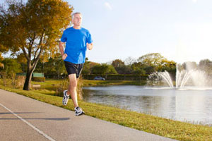 older man running in a park