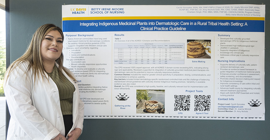 Nurse in white coat stands beside a research poster titled “Integrating Indigenous Medicinal Plants into Dermatologic Care in a Rural Tribal Health Setting.”