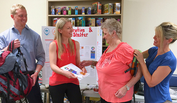 Master’s-degree leadership students John Eichenberger, left, Anna Olszewski and Wendin Gulbransen discuss emergency preparedness tips with Amador County resident Donna Drakos, center right, during a workshop for seniors.