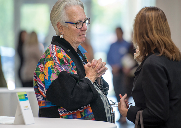 Interim Dean Debbie Ward welcomes a guest to the festivities.