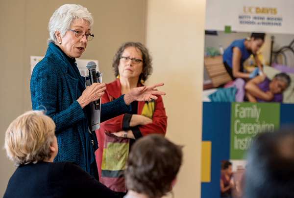 Chris Cassel, left, planning dean for the Kaiser Permanente School of Medicine, addresses the summit audience. Diana Mason, right, a professor at George Washington School of Nursing, serves as facilitator.