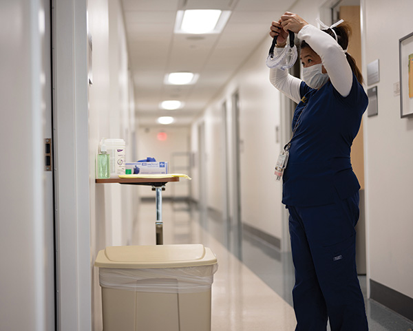 nurse putting on ppe