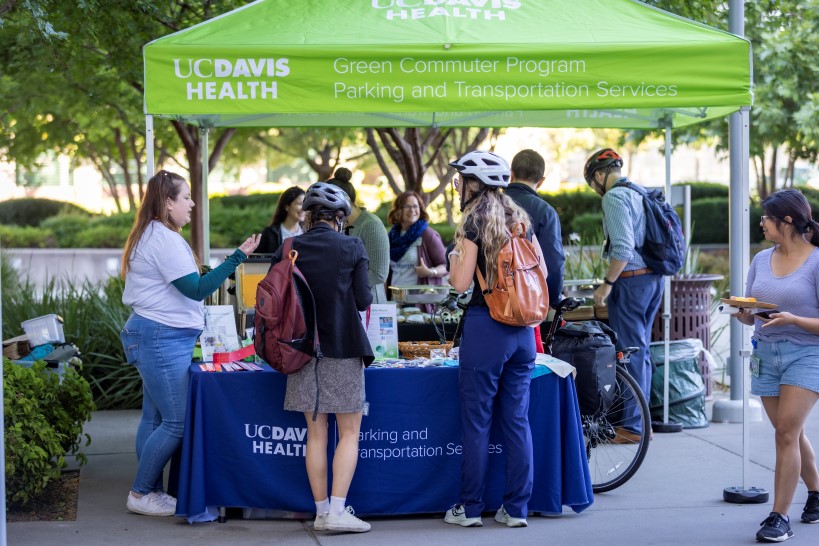 employees visiting a booth, outdoors