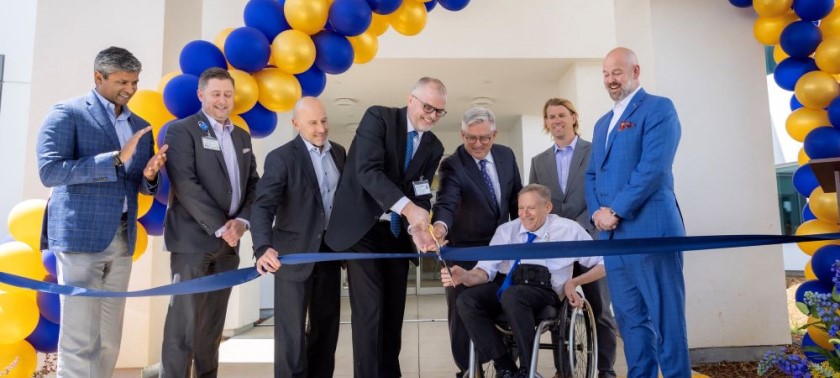 A group of people gathered for ribbon cutting ceremony