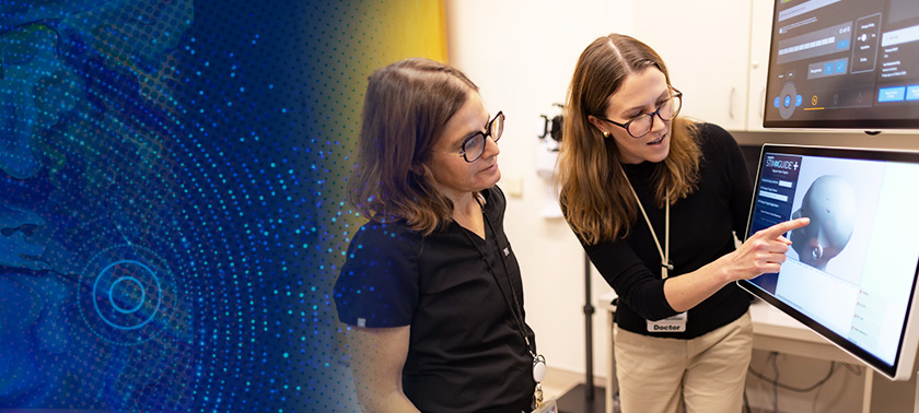 Psychiatrists Debra Kahn and Katharine Marder view an image on the TMS device.