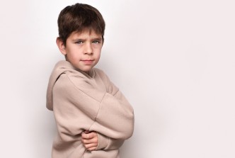 Stock image of a young boy looking angry