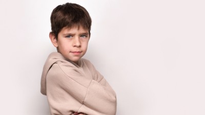 stock image of young boy looking angry