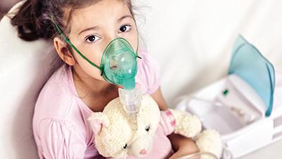 Young girl receiving asthma treatment