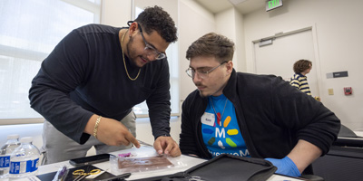 Community college students practice suturing skills. (C) UC Davis Regents. All rights reserved.