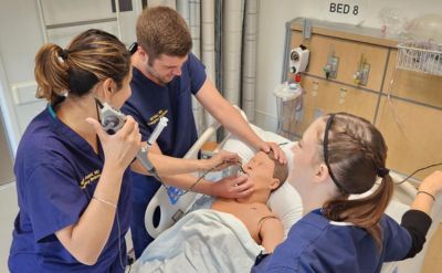 Emergency medicine clinicians work on a simulation mannequin. (C) UC Davis Regents.