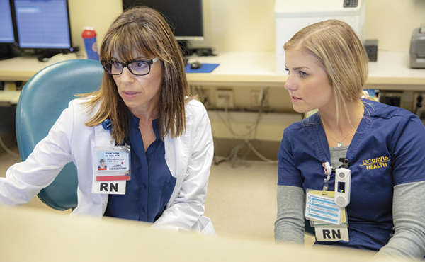 Carol Leija consults with Emily Becker.