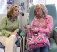 PHOTO — Alexis Von Aesch, 13, unwraps a blanket made by a Keaton Raphael Memorial volunteer. Robyn Raphael delivered the gift, one of many to the Von Aesch family, during one of Alexis' visits to the UC Davis Cancer Center's Pediatric Infusion Clinic.