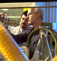 Photo — Chemistry professor Michael Nantz, right, and graduate student Hasan Palandoken synthesize prodrugs that kill glioma cells but not healthy brain cells.