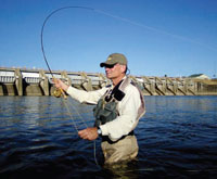 PHOTO — Just days after his final proton-beam treatment, Michael Bone was back to fly fishing.