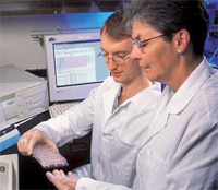 PHOTO — Marta Van Loan, right, with chemist Erik Gertz conducting a bone marker assay)