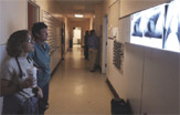 PHOTO -- Cheryl London, foreground, views Basil's chest films. Once filled with cancer, the dog's lungs have been clear for two years, thanks to an experimental drug.